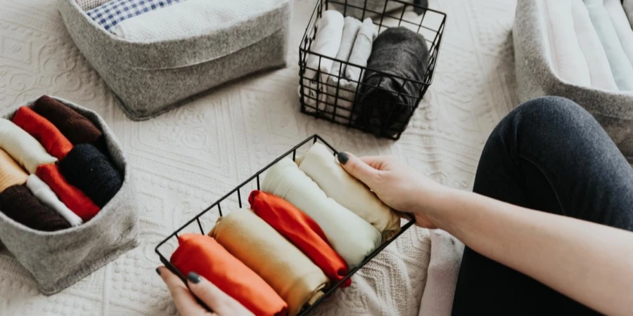 Folding clothes and organizing stuff in boxes and baskets