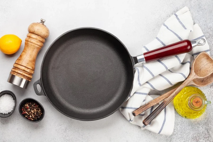 Frying pan, utensils and ingredients on kitchen table