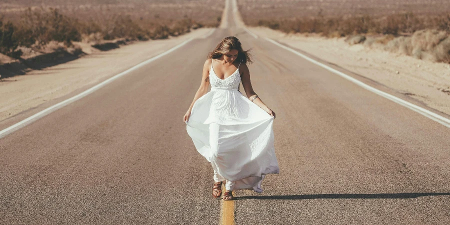 young female in maxi white dress