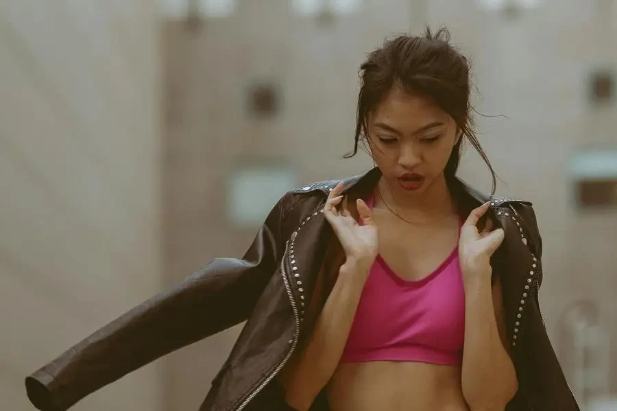 Girl Wearing Pink Top Uncovering Belly Yellow Pants and Black Leather Jacket by Jace Oner