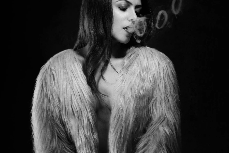 Grayscale Photo of Woman Wearing Fur Jacket