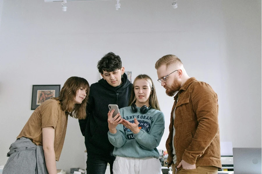 Group of Friends Standing and Looking on a Smartphone