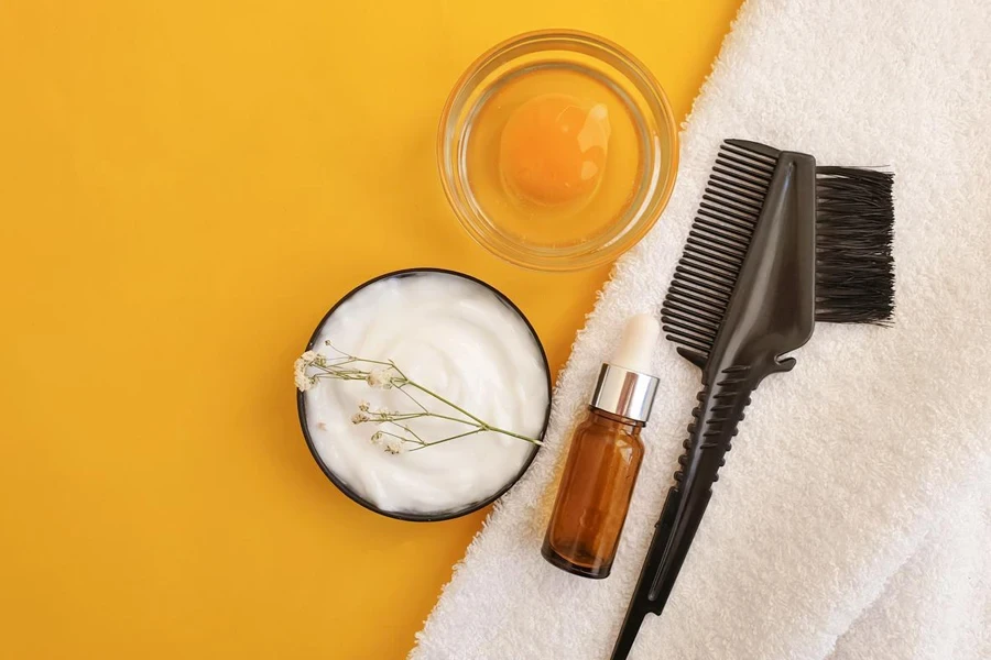 Hair mask, comb on a colored background