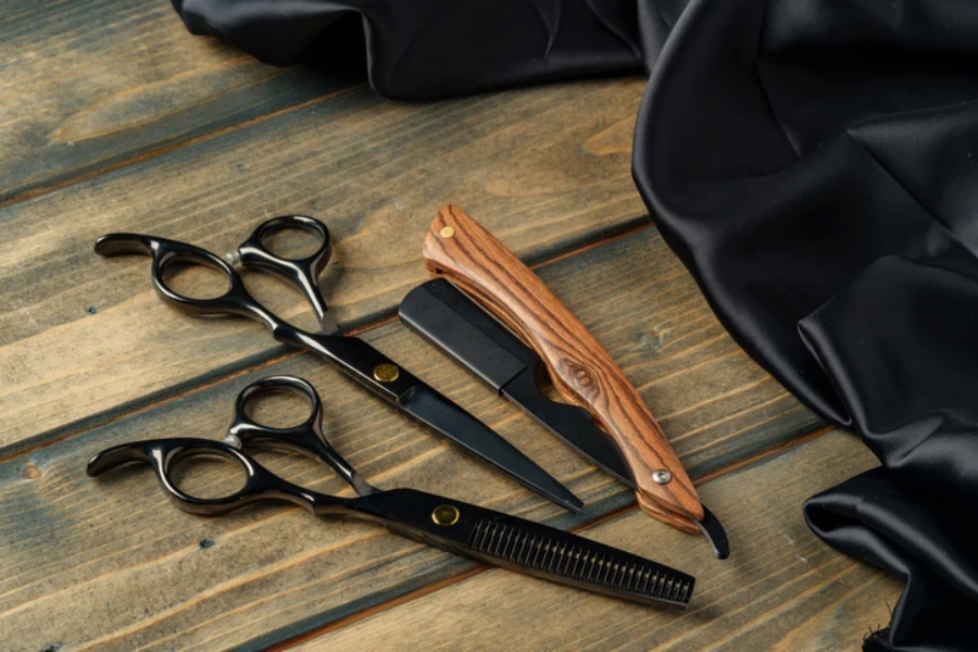 Hairdressing professional scissors on wooden background close up photo