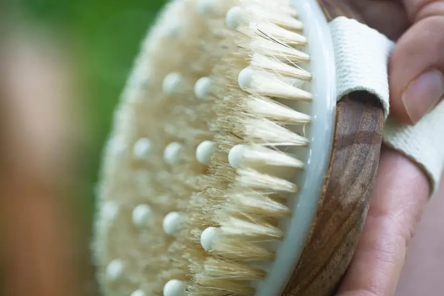 Hand Holds A Skin Exfoliator Towards The Camera