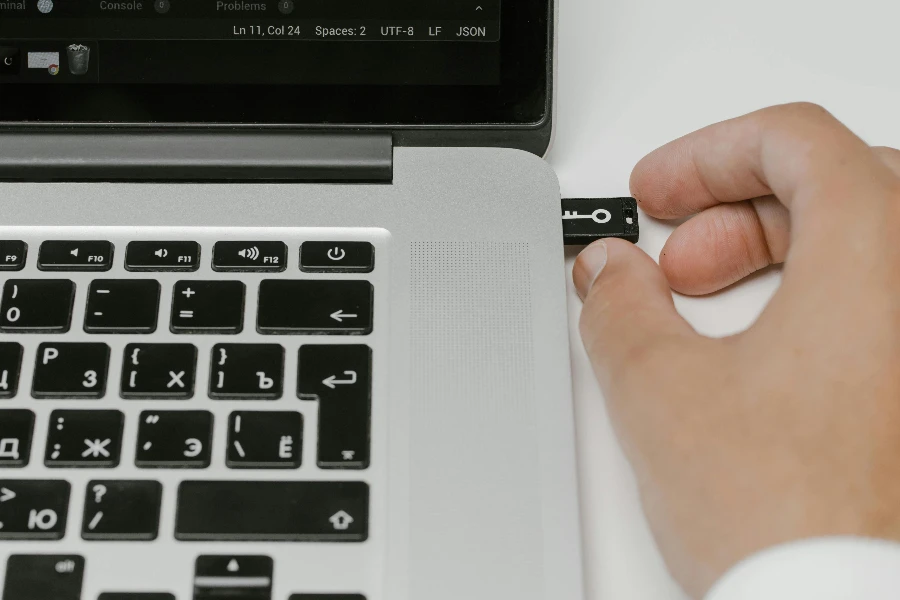 Hand Putting a USB Flash Drive in a Laptop by cottonbro studio
