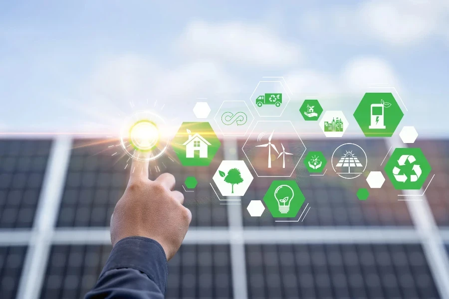 Hand with an icon of energy in front show symbols of various energies with a solar cell in the background