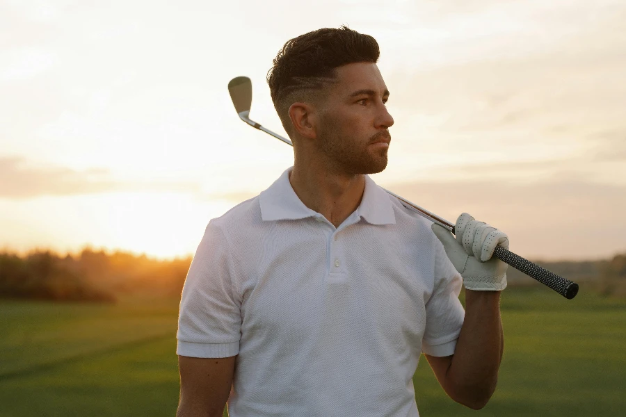 Handsome Man in White Polo Shirt Posing with Golf Club