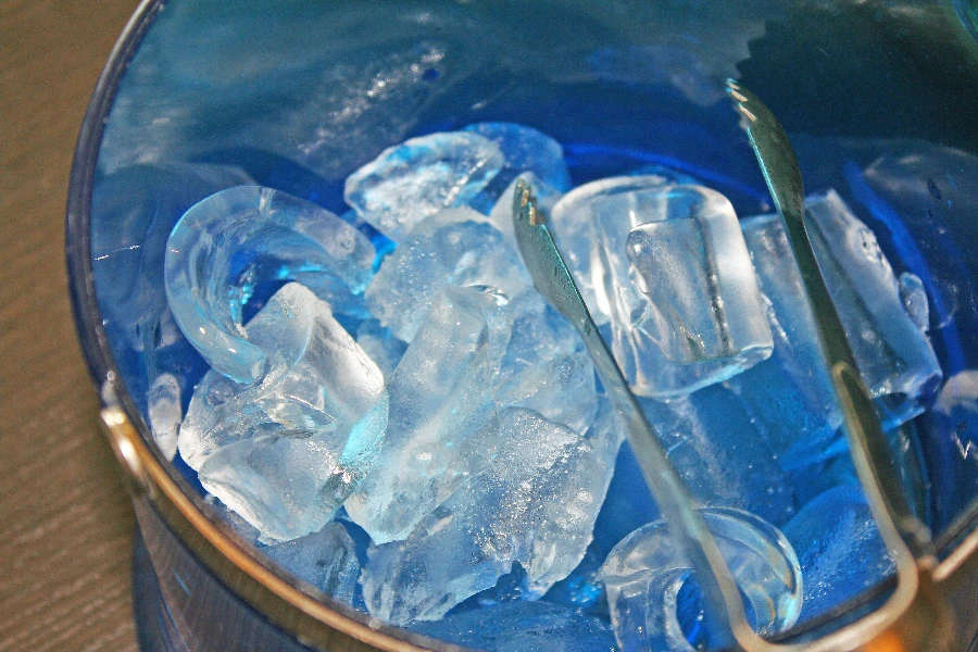 Ice in blue transparent plastic bucket