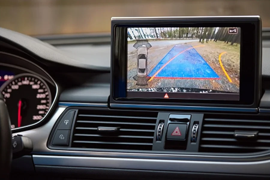 Interior of premium car with rearview camera dynamic trajectory turning lines and parking assistant steering wheel turned right.