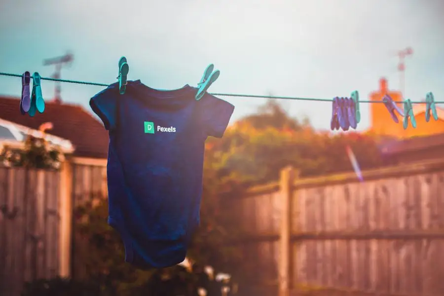 Kids Blue Shirt hanging on the clothesline by Lisa Fotios