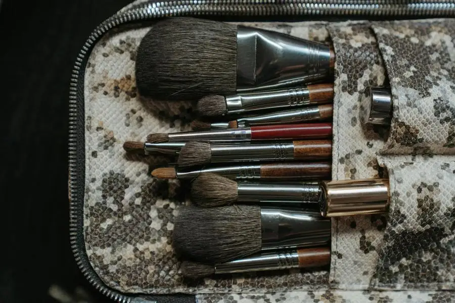 Makeup Brushes on Brown and White Textile by cottonbro studio