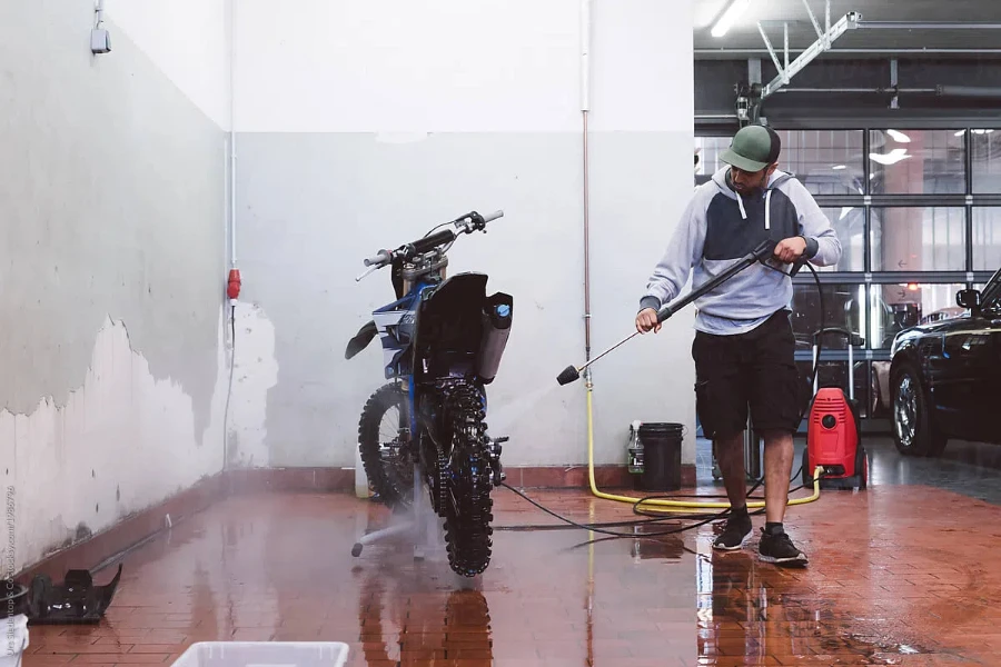 Man Cleans His Motocross Bike With Pressure Washer