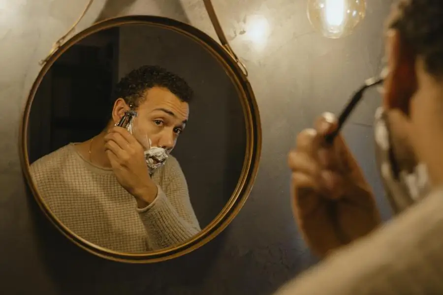 Man Shaving in Front of Mirror by Tima Miroshnichenko