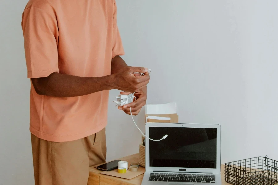 Man Standing Next to Desk