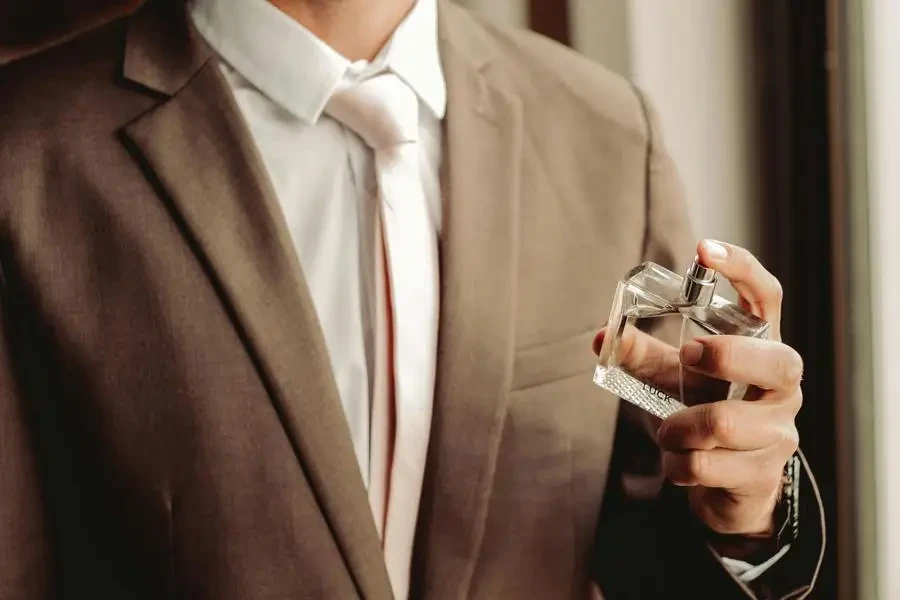 Man Wearing Suit and Necktie with Perfume Bottle by Duané Viljoen