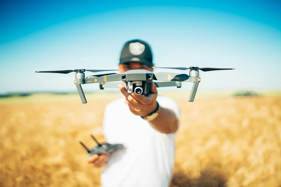 Man holding a drone in a field