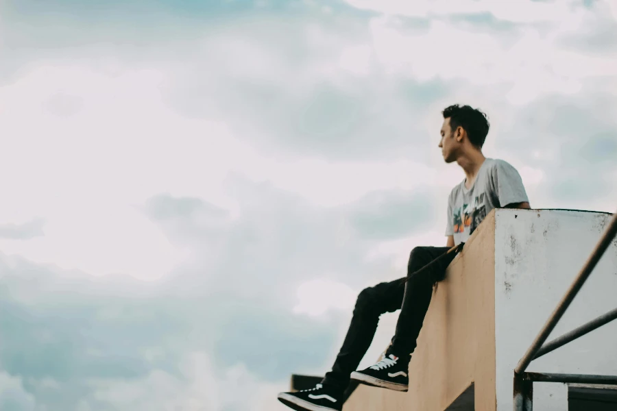 Man in Gray Shirt a Sitting on the Edge