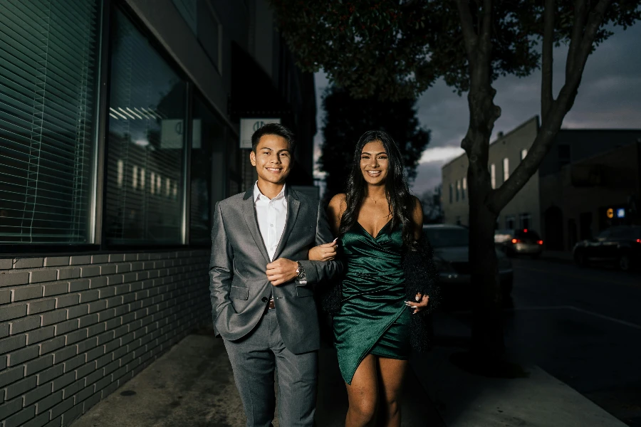 Man in Gray Suit Standing Beside Woman in Green Dress by Juan Vargas