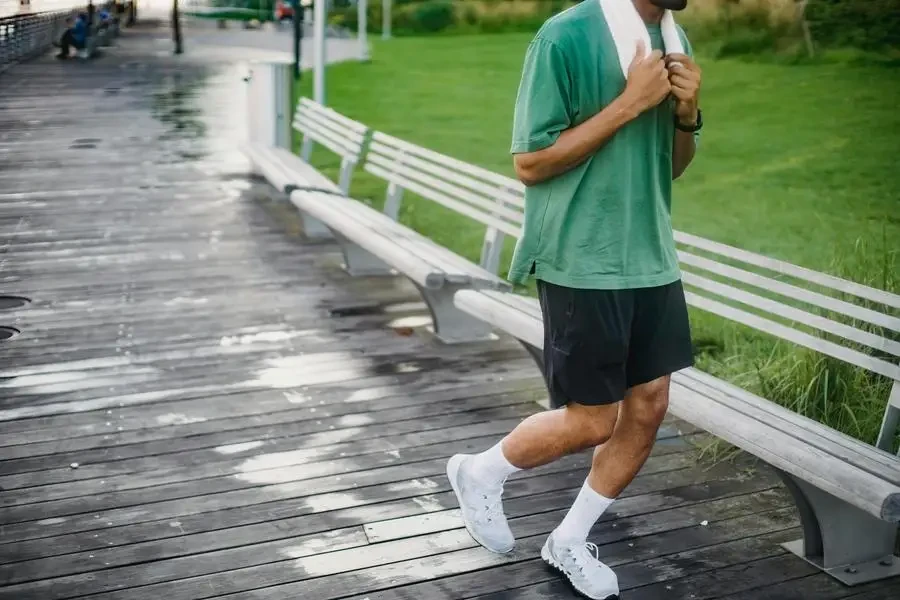 Man in Green T-shirt Jogging on Boardwalk by Ketut Subiyanto