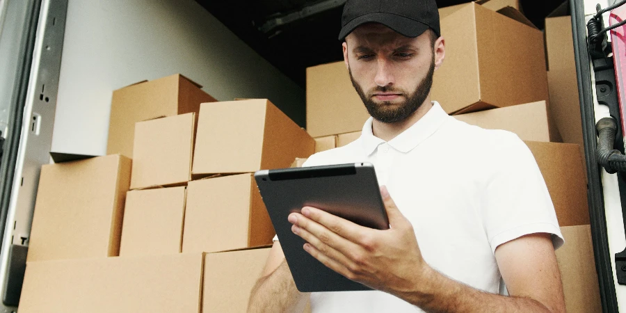 Man in White Polo Shirt Using a Tablet Computer