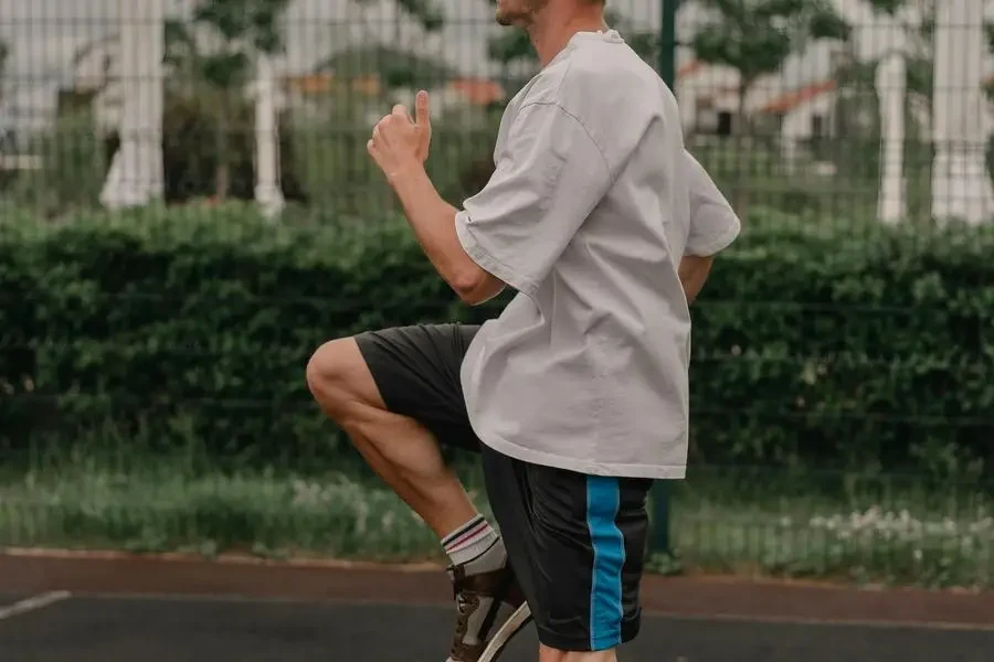 Man in White Shirt Wearing Rubber Shoes While Running by ROMAN ODINTSOV