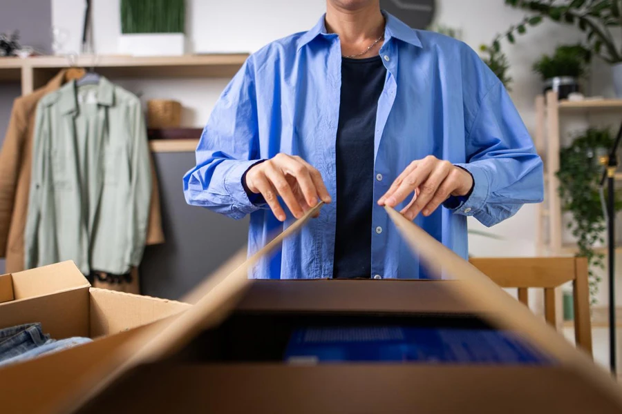 Man packing parcel in clothing store