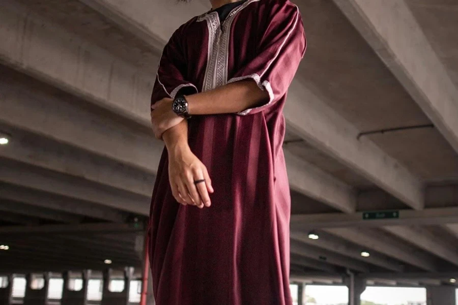 Man posing in a red thobe