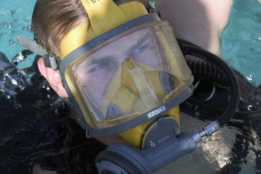Man wearing a full-face yellow diving mask