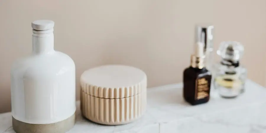 Marble shelf for cosmetics storage in modern bathroom by Karolina Kaboompics