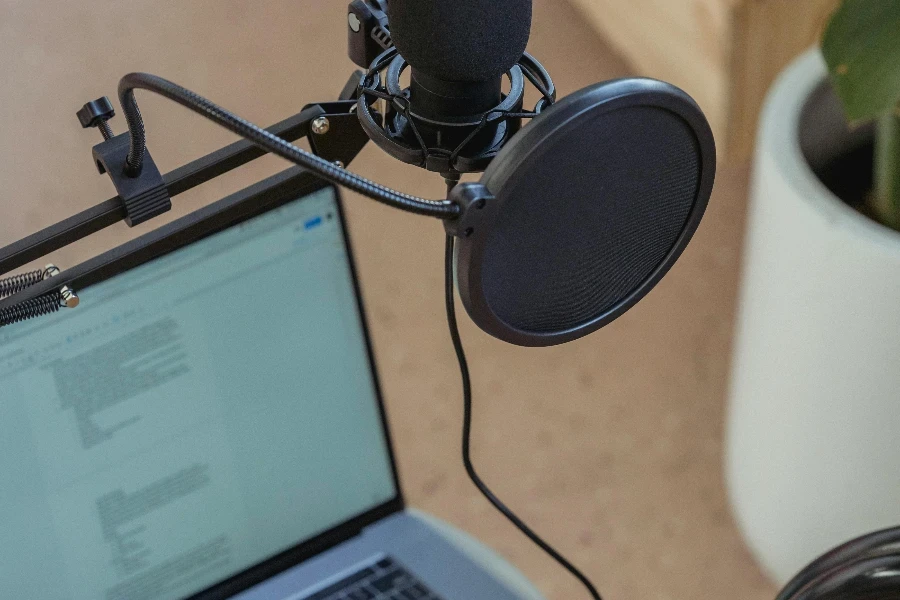 Microphone on tripod attached to laptop in studio