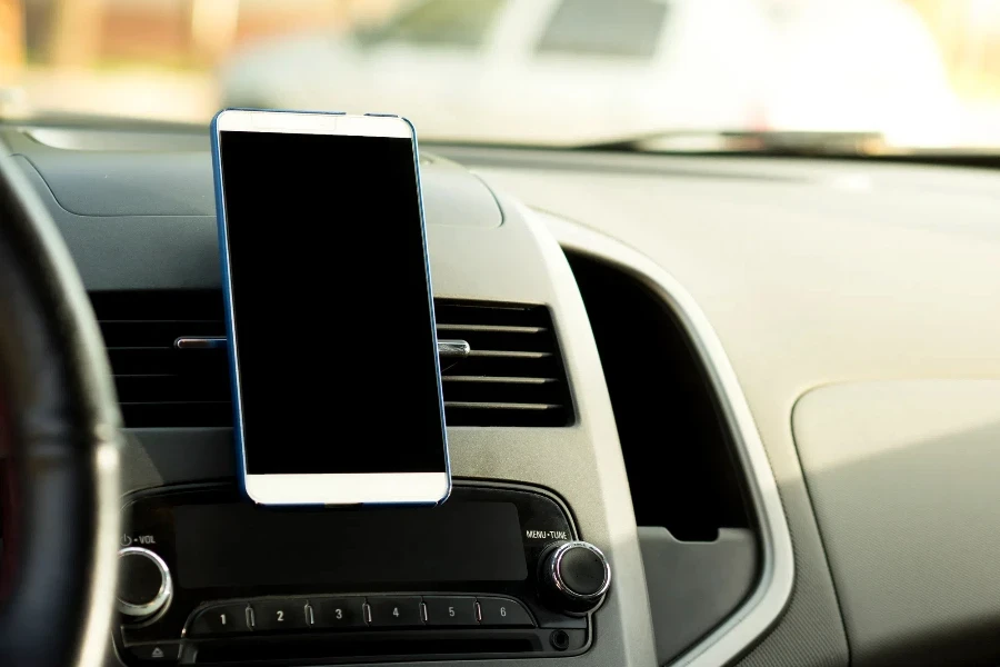 Mobile phone located in the center of the vehicle console.