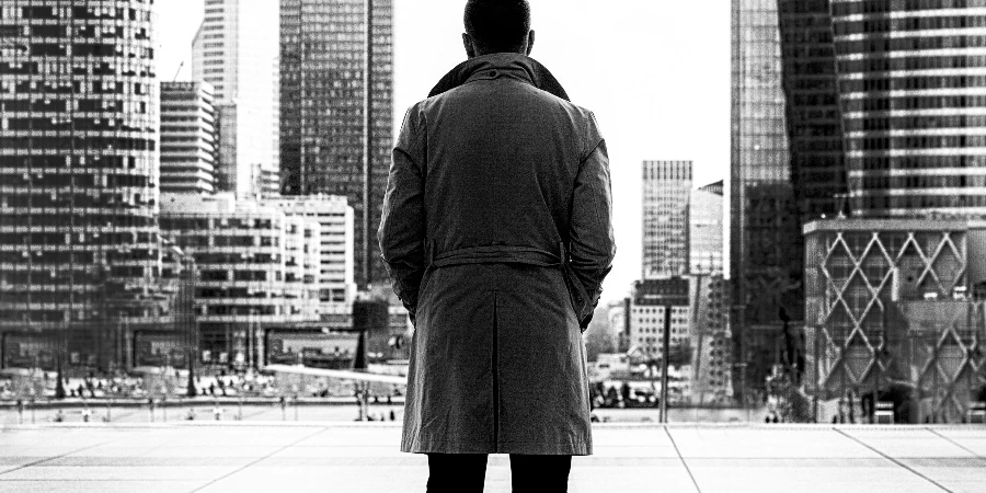 Monochrome Photo of Man Wearing Trench Coat