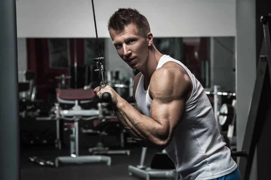 Muscular man during workout in the gym