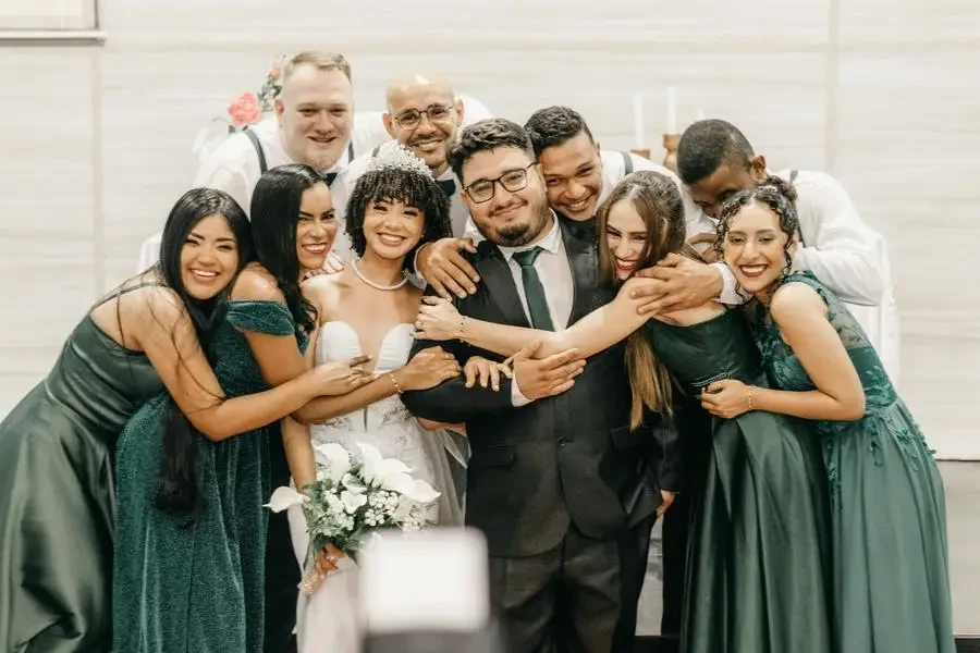 Newlyweds and Guests Smiling Together by Kawê Rodrigues