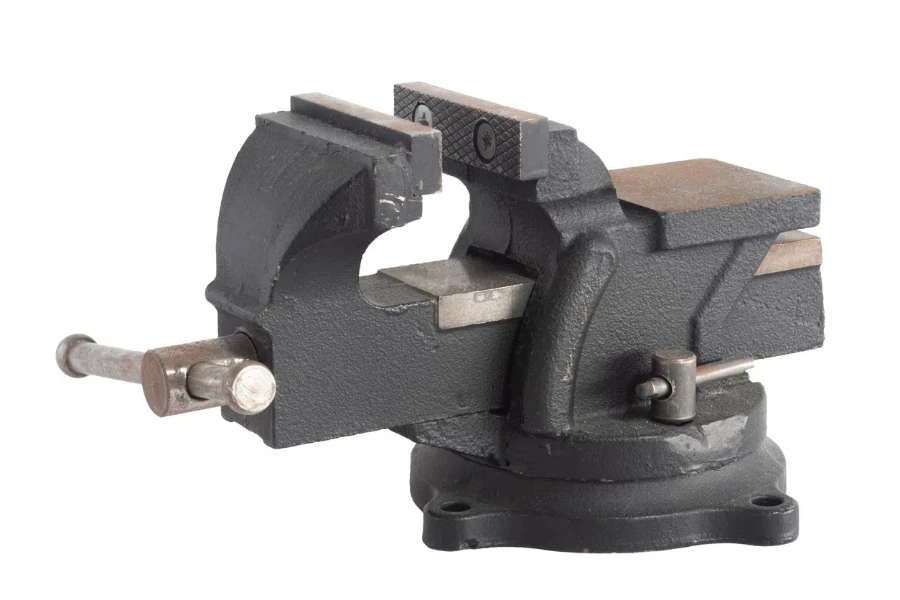 Old black vise on white background