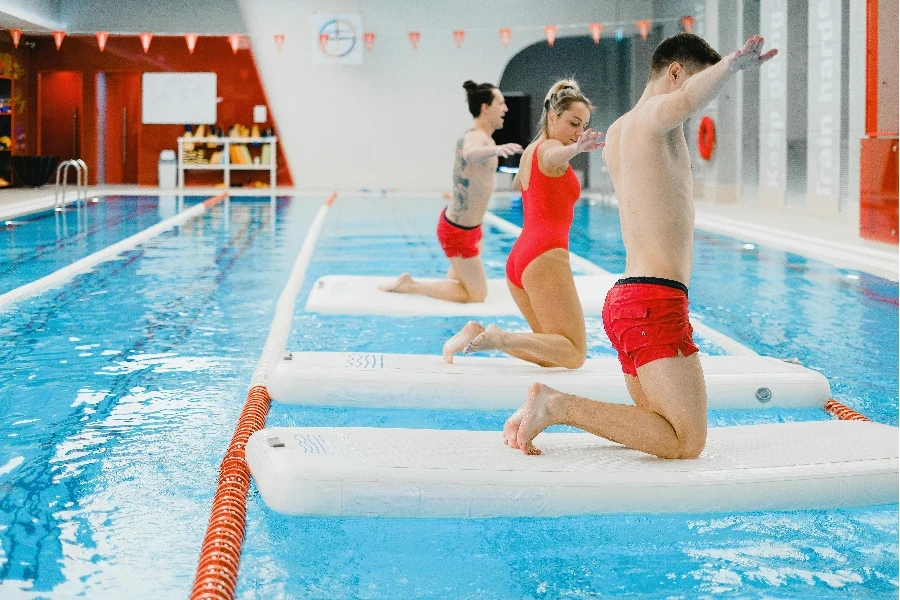 People Exercising on Floating Boards in an Indoor Swimming Pool