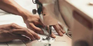 Person Holding Sewing Machine by Wallace Chuck