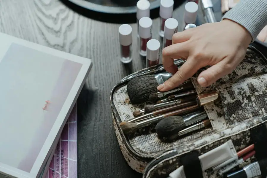 Person Holding White and Brown Makeup Brush Set by cottonbro studio