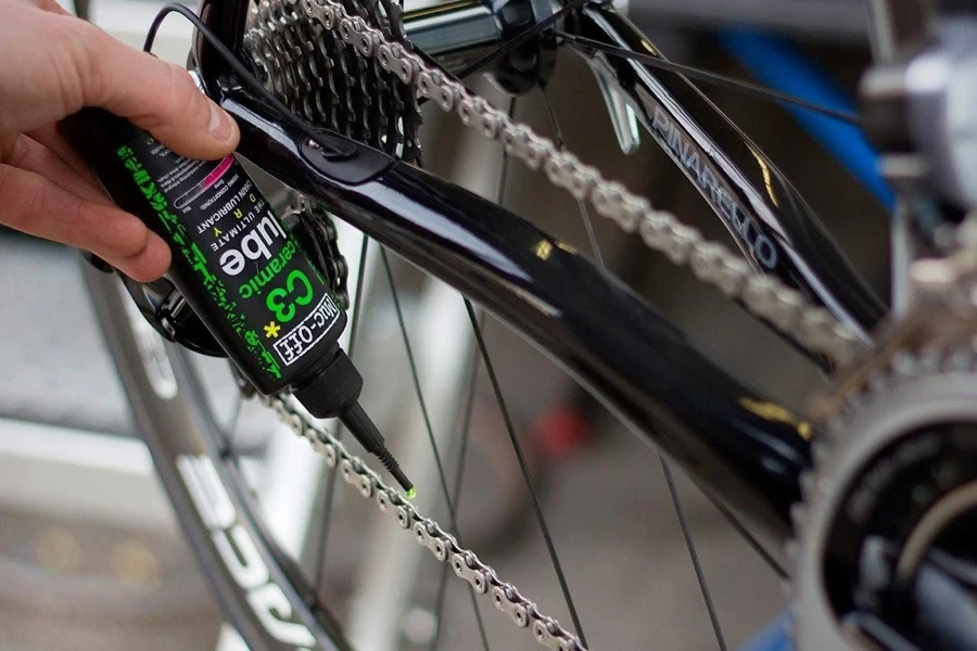 Person applying ceramic lubes on a bike chain