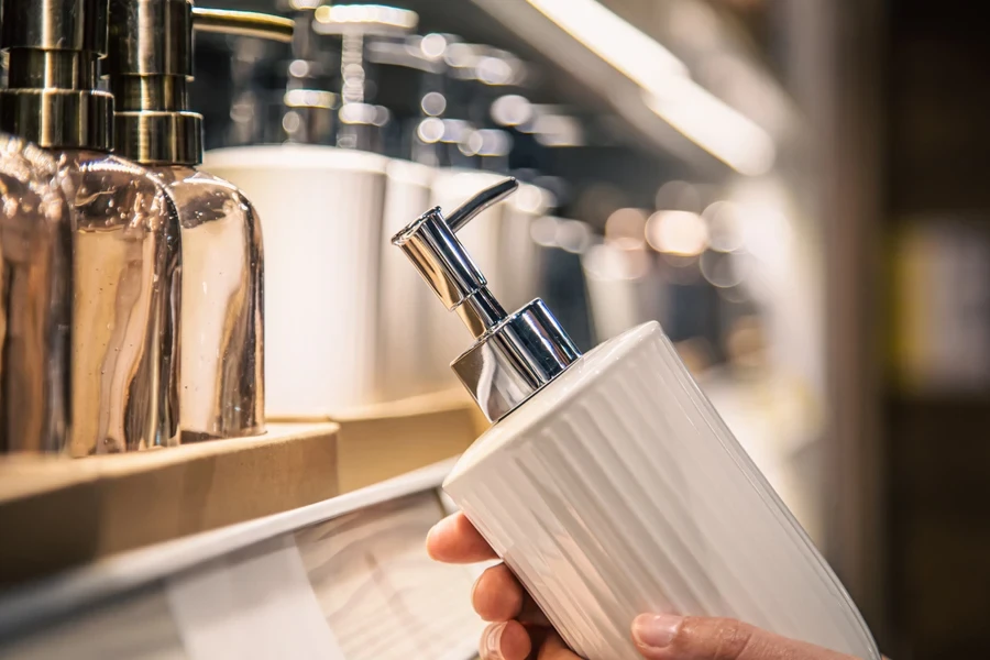 Person holding an unbranded soap dispenser