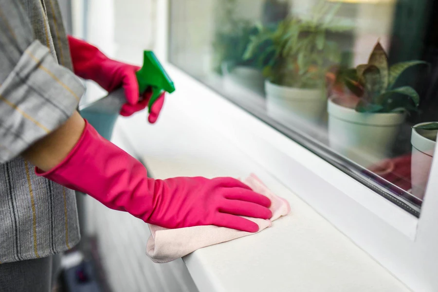 Person in Red Long Sleeve Shirt Holding Green Plastic Tool