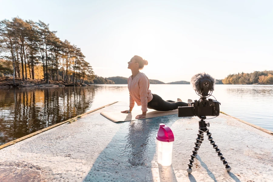 Person recording themselves doing yoga outside