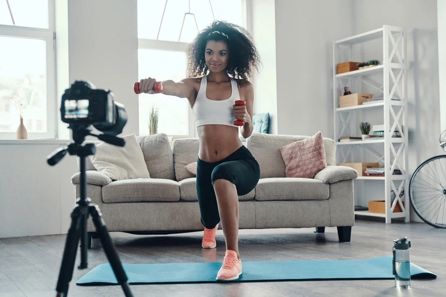 Person recording themselves working out at home