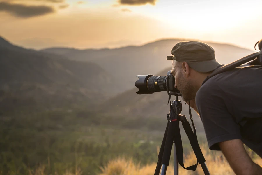 Person taking a photo outside on a tripod