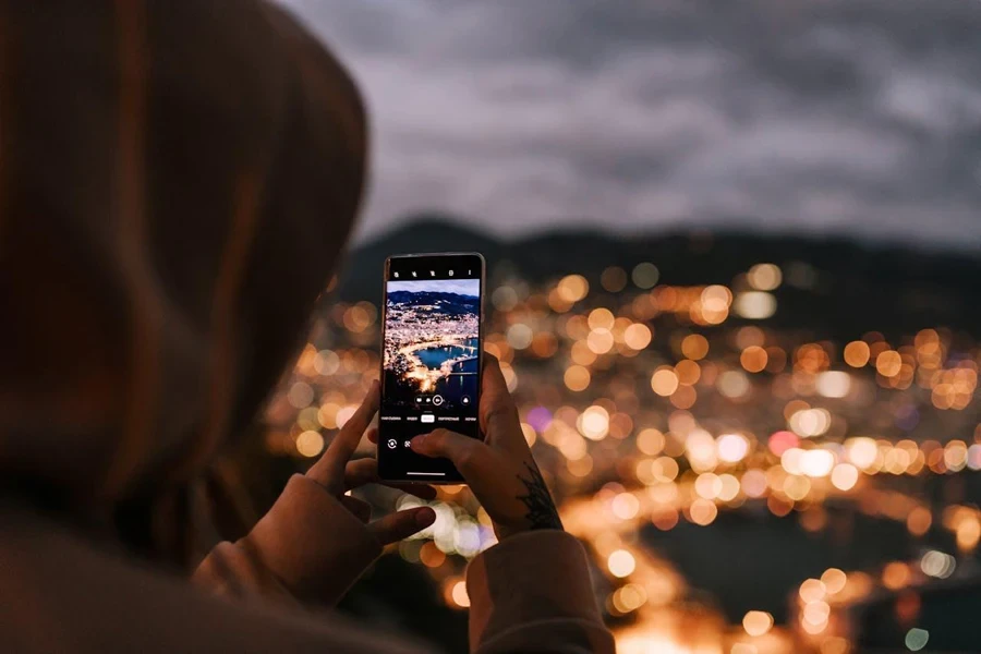 Person taking a picture of a city with a smartphone