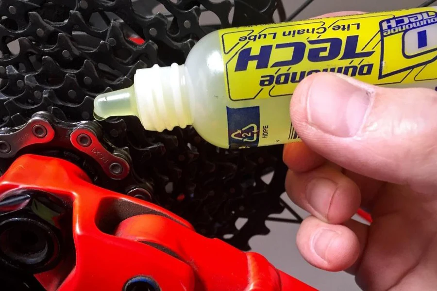 Person using a travel-sized bike lube