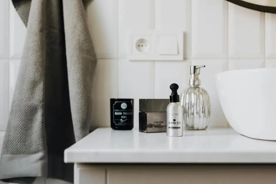 Personal care supplies on cabinet in stylish bathroom by Karolina Kaboompics