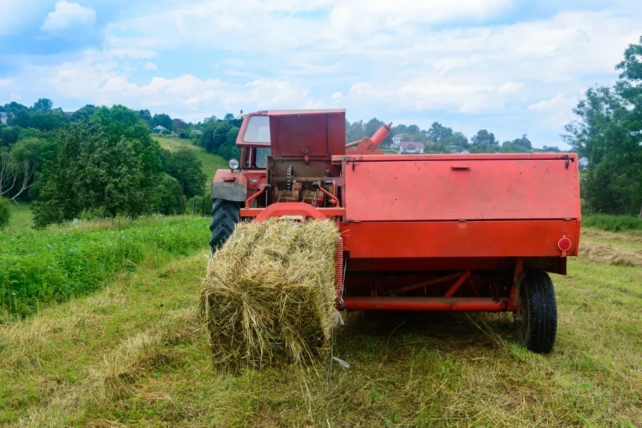 Pressing hay into bales, old working press, harvesting and harvesting dry fodder