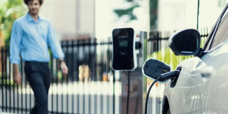 Progressive concept of focus EV car at charging station with blur man background